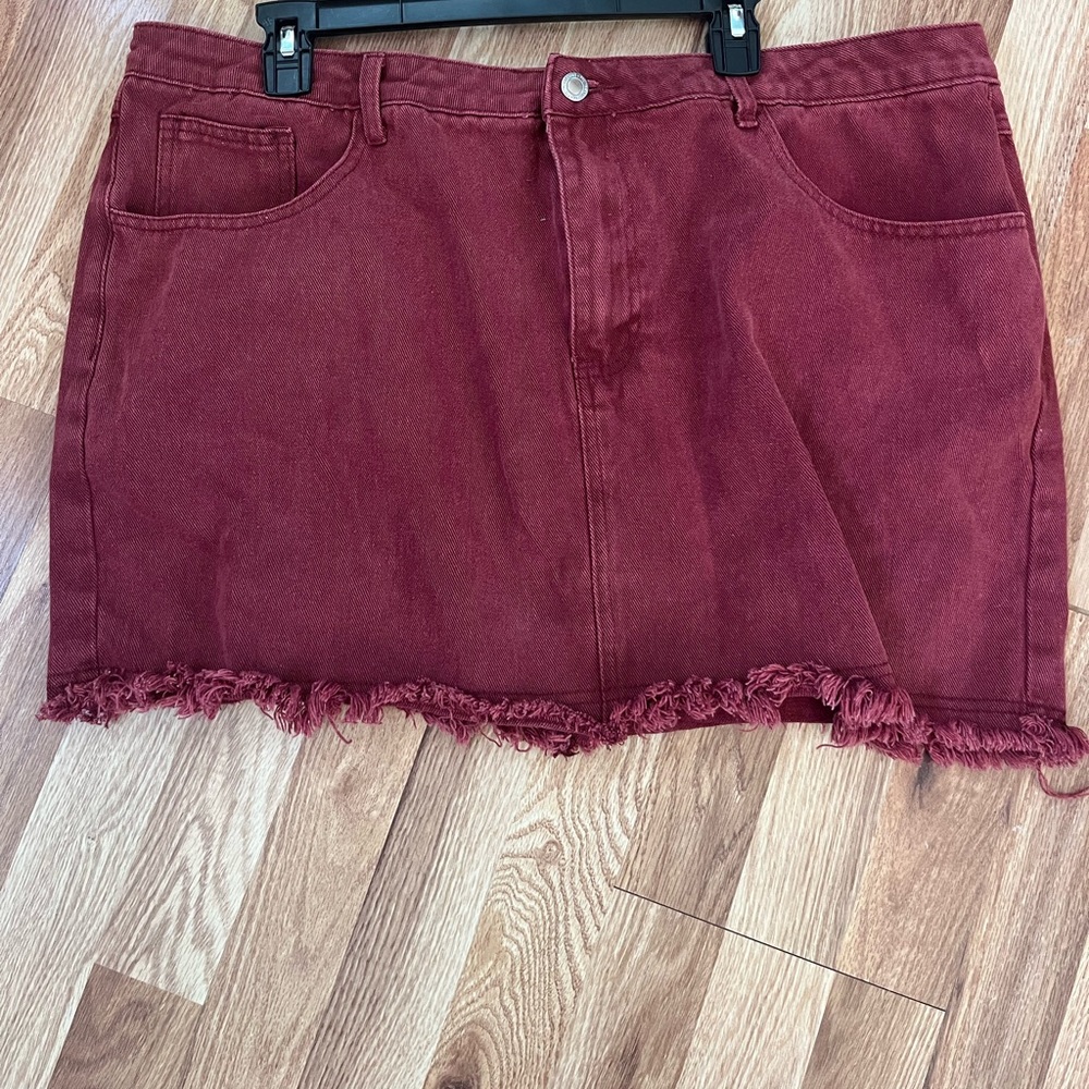 Adorable maroon denim mini with distressed hem.
